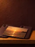 Two phones face-down side by side with one printed photograph resting across both.