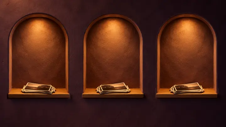 Three arched niches, all lit, each holding photographs: three rooms on this phone.